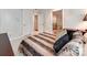 Comfortable bedroom with striped bedding and access to upper floor at 501 River Oaks Ln, Charlotte, NC 28226