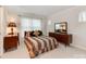 Bedroom with plush carpeting, a vintage dresser, and a comfortable bed with decorative pillows at 501 River Oaks Ln, Charlotte, NC 28226