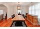 Elegant dining room featuring a custom wood table, hardwood floors, and designer lighting, perfect for entertaining and Gathering meals at 501 River Oaks Ln, Charlotte, NC 28226