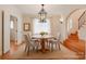 Cozy dining room with warm hardwood floors, chandelier, and an adjacent staircase at 501 River Oaks Ln, Charlotte, NC 28226