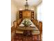 Bright dining room features a large wooden table set for dinner and a rustic-chic chandelier at 501 River Oaks Ln, Charlotte, NC 28226