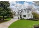 Beautiful two-story home with a lush green lawn and a paved driveway leading to the garage at 501 River Oaks Ln, Charlotte, NC 28226
