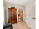 Hallway features tile floors, a wooden cabinet with storage, and a view of the staircase at 501 River Oaks Ln, Charlotte, NC 28226