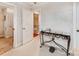 Hallway has a glass-topped table with wrought iron legs and leads to the staircase at 501 River Oaks Ln, Charlotte, NC 28226