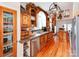 A spacious kitchen featuring custom wood cabinetry, stainless steel appliances, and unique pot rack at 501 River Oaks Ln, Charlotte, NC 28226