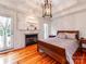 Bedroom with hardwood floors, fireplace, and French doors leading to the outside at 501 River Oaks Ln, Charlotte, NC 28226