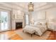 Bright main bedroom with hardwood floors, fireplace, and French doors leading to the exterior at 501 River Oaks Ln, Charlotte, NC 28226