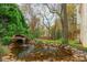 Backyard view of a rock-lined koi pond with waterfall at 501 River Oaks Ln, Charlotte, NC 28226
