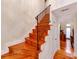 Elegant staircase with wooden steps, a wrought iron railing, and an inviting view to the living spaces at 501 River Oaks Ln, Charlotte, NC 28226