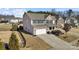 Aerial view of a two-story home featuring a brick facade, attached two-car garage, and well-manicured lawn at 5011 Tatton Ln, Indian Land, SC 29707