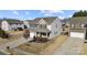 Aerial view of a two-story home featuring a brick facade, attached two-car garage, and well-manicured lawn at 5011 Tatton Ln, Indian Land, SC 29707