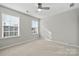 Bright bedroom with two windows, ceiling fan, and neutral walls at 5011 Tatton Ln, Indian Land, SC 29707