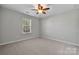 Cozy bedroom with carpeted floor, a window, and ceiling fan at 5011 Tatton Ln, Indian Land, SC 29707