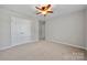 Bright bedroom with double doors to closet and ceiling fan at 5011 Tatton Ln, Indian Land, SC 29707