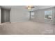 Spacious bedroom with carpet, ceiling fan, and two windows at 5011 Tatton Ln, Indian Land, SC 29707