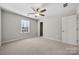 Spacious bedroom with ceiling fan, window, and neutral decor at 5011 Tatton Ln, Indian Land, SC 29707