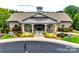 Community clubhouse featuring stone and siding, and a covered entryway with rocking chairs at 5011 Tatton Ln, Indian Land, SC 29707