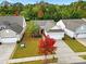 An aerial view of a well-maintained house with beautiful landscaping and mature trees at 20195 Dovekie Ln, Fort Mill, SC 29707