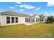 Backyard of house with new lawn, landscaping, and freshly painted trim at 20195 Dovekie Ln, Fort Mill, SC 29707