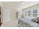Cozy bedroom with a charming armoire, soft carpet, and a comfortable bed by the bright windows at 20195 Dovekie Ln, Fort Mill, SC 29707