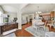 Open-concept dining area with hardwood floors and elegant chandelier adjacent to the kitchen and living spaces at 20195 Dovekie Ln, Fort Mill, SC 29707