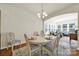Cozy dining area with modern chandelier, light colored furniture, and seamless access to living room at 20195 Dovekie Ln, Fort Mill, SC 29707