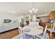 Elegant dining area with a chandelier, hardwood floors, and a view into the living room and kitchen at 20195 Dovekie Ln, Fort Mill, SC 29707