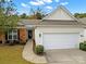 Charming home featuring a two-car garage and a mix of brick and siding on the exterior at 20195 Dovekie Ln, Fort Mill, SC 29707