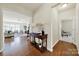 Inviting hallway with hardwood floors, console table, and an open view into a bright living room at 20195 Dovekie Ln, Fort Mill, SC 29707
