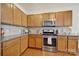 Well-equipped kitchen with stainless steel appliances, granite countertops, and wooden cabinets at 20195 Dovekie Ln, Fort Mill, SC 29707