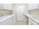 This spacious laundry room has a washer, dryer, and storage space at 20195 Dovekie Ln, Fort Mill, SC 29707