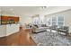 Bright living room with hardwood floors, large windows, and stylish furniture offering an open layout at 20195 Dovekie Ln, Fort Mill, SC 29707