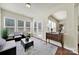 Bright sunroom filled with natural light, featuring a decorative rug, a seating area, and access to the outdoors at 20195 Dovekie Ln, Fort Mill, SC 29707