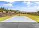 Backyard featuring a basketball court, a fence, and a beautiful lawn at 3157 Delaware Dr, Denver, NC 28037