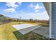 Beautiful backyard with a basketball court, fence, and well-maintained lawn and landscaping at 3157 Delaware Dr, Denver, NC 28037