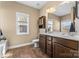 Bathroom featuring dual sinks, good lighting, and vanity storage at 3157 Delaware Dr, Denver, NC 28037