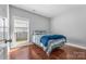 Bright bedroom with hardwood floors, window, and natural light at 3157 Delaware Dr, Denver, NC 28037