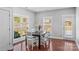 A sunny dining area with wood floors, bright windows, and access to outdoor space at 3157 Delaware Dr, Denver, NC 28037