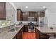 Well-equipped kitchen featuring granite countertops, stainless steel appliances, and dark wood cabinetry at 3157 Delaware Dr, Denver, NC 28037