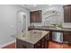 A kitchen featuring granite countertops, stainless steel appliances and a view to the living room at 3157 Delaware Dr, Denver, NC 28037