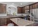 A kitchen showcasing granite countertops, stainless steel appliances, and dark wood cabinetry at 3157 Delaware Dr, Denver, NC 28037