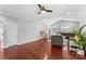 Open-concept living room with hardwood floors, bright windows, and a ceiling fan at 3157 Delaware Dr, Denver, NC 28037
