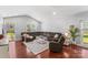 Inviting living room with hardwood floors, large windows, sectional seating, and a ceiling fan at 3157 Delaware Dr, Denver, NC 28037