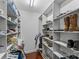 Walk-in closet with custom shelves, closet rods and wood flooring offers ample storage space at 3157 Delaware Dr, Denver, NC 28037