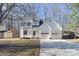 Two-story house with attached two-car garage and landscaped yard at 7033 Rothmore St, Charlotte, NC 28215