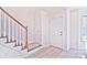 Wooden staircase with white railing and light flooring at 7033 Rothmore St, Charlotte, NC 28215