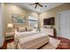 Bright and airy bedroom with a bed, hardwood floors, dresser, and neutral color scheme at 8703 Kentucky Derby Dr, Waxhaw, NC 28173