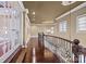 Spacious upstairs hallway featuring hardwood floors, decorative railings, and a stained glass skylight at 8703 Kentucky Derby Dr, Waxhaw, NC 28173