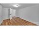 Basement area featuring wood laminate flooring and white painted doors at 508 Deese St, Monroe, NC 28112