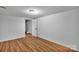 Finished basement area with laminate flooring and a white door leading to another room at 508 Deese St, Monroe, NC 28112